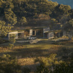 3D rendering of a freestanding villa in a forested hillside landscape
